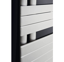 Gros plan d'un radiateur de salle de bain blanc avec des éléments chauffants horizontaux.