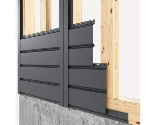 Revêtement de façade sur un mur de maison avec cadre en bois et socle en béton