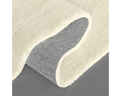 Vue détaillée d'un tapis beige avec envers textile