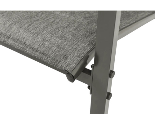 Gros plan d'un banc de jardin avec assise en textile et structure en métal.