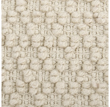 Gros plan d'un tapis beige à structure à picots