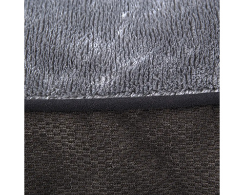 Gros plan d'un tapis de bain gris avec deux textures différentes