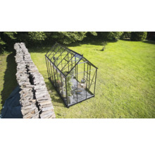 Serre avec verre et cadre en métal dans le jardin