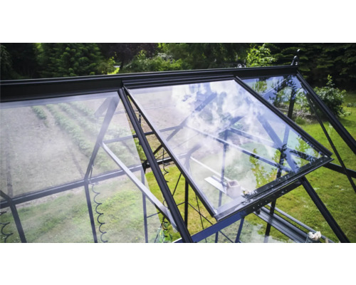 Serre avec fenêtres ouvertes dans le jardin