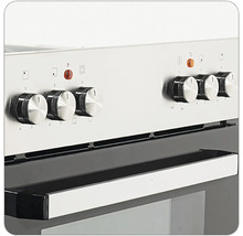 Vue détaillée d'une cuisinière avec des boutons rotatifs pour le réglage de la température et la sélection des fonctions