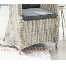 Gros plan d'un fauteuil en rotin avec coussins d'assise gris