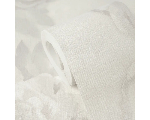 Rouleau de papier peint avec surface texturée et motif floral discret.