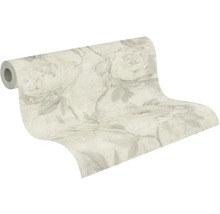 Rouleau de papier peint avec grand motif floral et motifs de feuilles.