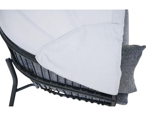 Détail d'une chaise de jardin avec cadre en métal foncé, coussin et revêtement en tissu blanc.