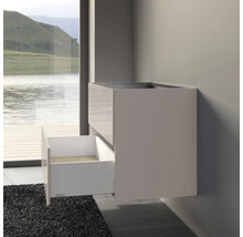 Meuble sous-lavabo avec tiroir sur un mur de salle de bain