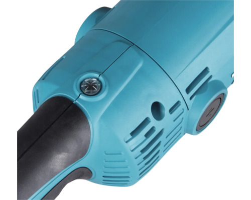 Gros plan du boîtier d'un outil électrique avec fentes d'aération et couvercle à vis pour le remplacement des charbons.