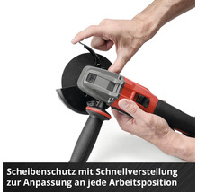 Une personne ajuste le capot de protection d'une meuleuse d'angle rouge et noire