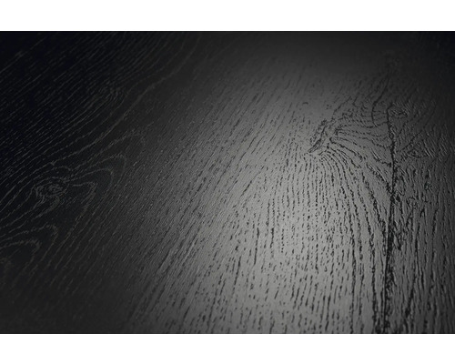 Gros plan d'une surface de sol sombre avec un aspect bois, des veines et des nœuds prononcés.