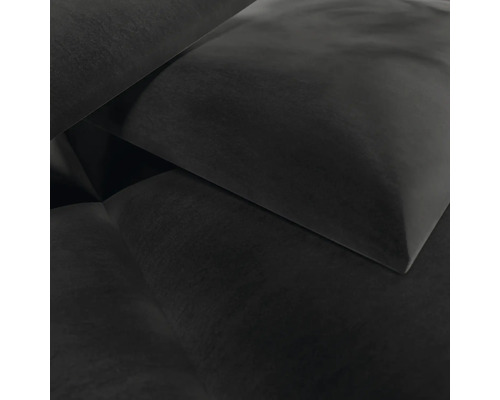 Gros plan d'un tissu d'ameublement foncé sur un coussin ou un canapé.