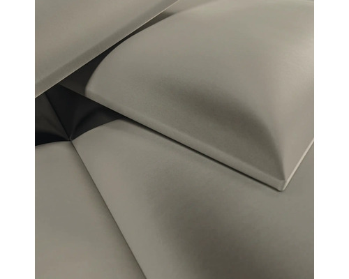 Gros plan de panneaux muraux rembourrés avec une surface en tissu doux et des bords arrondis.