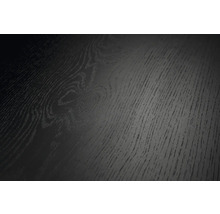 Vue rapprochée d'une surface noire à l'aspect bois avec veinure et texture marquées.
