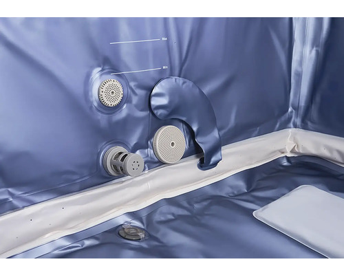 Vue intérieure d'un spa gonflable avec repères de niveau d'eau minimum et maximum et divers raccords pour filtres.