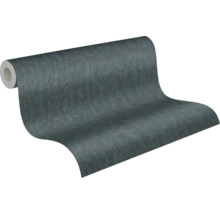 Papier peint intissé avec une surface structurée en anthracite et doré, rouleau partiellement déroulé.