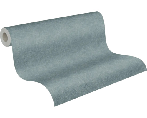Papier peint intissé bleu gris texturé aspect lin sur rouleau.