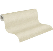 Papier peint intissé structuré beige, uni, partiellement déroulé.