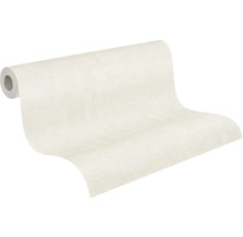 Rouleau de papier peint intissé partiellement déroulé avec une structure discrète.