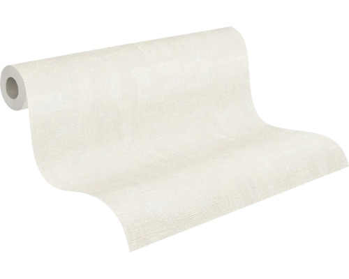 Rouleau de papier peint intissé partiellement déroulé avec une structure discrète.