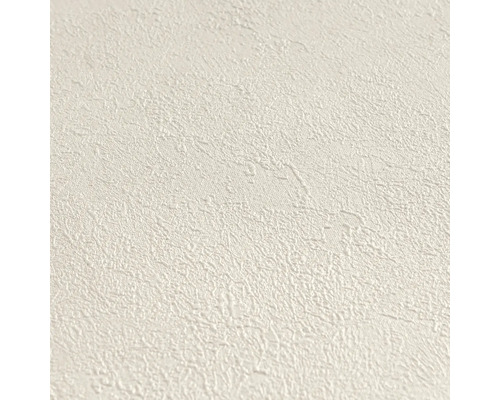 Papier peint intissé structuré avec un grain fin et irrégulier en crème.