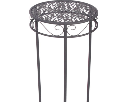 Support pour plantes rond en métal avec plateau perforé et ornements décoratifs sur trois pieds.