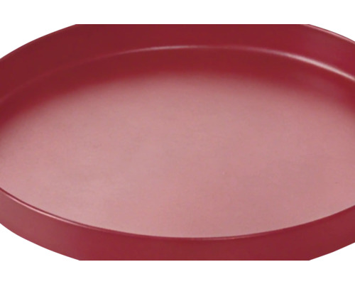Soucoupe ronde rouge avec bord relevé.