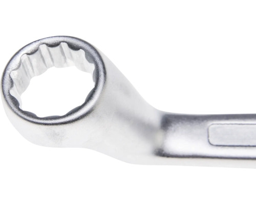 Gros plan de la tête d une clé polygonale en métal chromé avec profil à douze pans.
