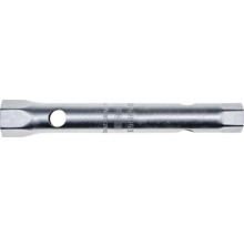 Clé à tube double en acier avec profil hexagonal et perçage pour broches.