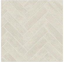 Carreaux de sol ou muraux clairs avec motif en chevrons et texture aspect pierre.