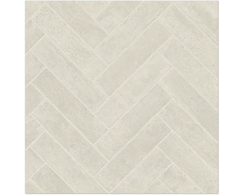 Carreaux de sol ou muraux clairs avec motif en chevrons et texture aspect pierre.