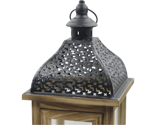 Partie supérieure d'une lanterne en bois brun et métal noir avec motif ajouré décoratif et poignée.