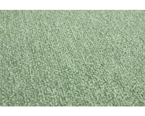 Gros plan de la structure de surface d'une moquette verte.