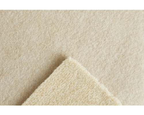 Gros plan de la texture d un tapis en feutre aiguilleté beige avec un coin replié.
