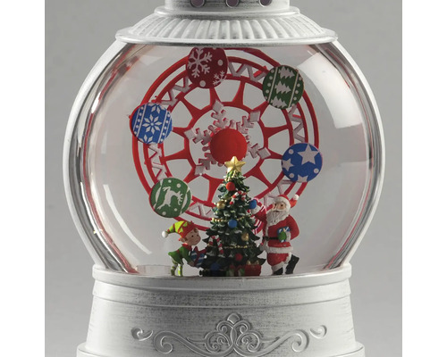 Boule à neige de Noël avec grande roue, sapin, Père Noël et elfe sur socle blanc.