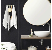 Salle de bain moderne avec miroir rond, vasque à poser blanche sur plan de toilette en bois et panneaux muraux sombres texturés.