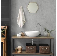 Modernes Badezimmer mit rundem Aufsatzwaschbecken, hoher Armatur und Waschtisch aus Holz und Metall. Über dem Becken hängt ein sechseckiger Spiegel.