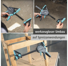 Wolfcraft Einhandzwinge zeigt den werkzeuglosen Umbau für Spreizanwendungen an einem hölzernen Möbelstück.