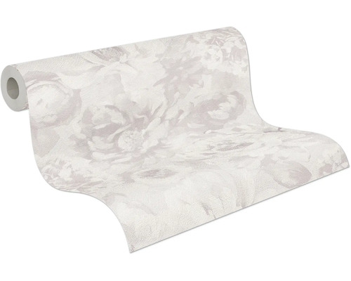 Papier peint intissé à grand motif floral, rouleau partiellement déroulé.
