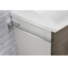 Meuble sous-vasque pour salle de bains avec lavabo intégré et porte-serviettes en métal monté sur le côté.
