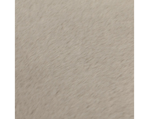 Gros plan sur la texture douce et pelucheuse d'un tapis aux fibres denses.