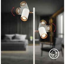 Lampadaire blanc avec deux spots orientables et détails en bois, pivotant à 360 degrés.