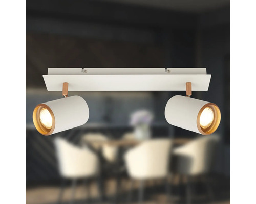 Plafonnier à deux spots en métal blanc avec des accents de cuivre et têtes orientables.