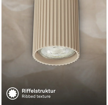 Vue détaillée d une applique de plafond cylindrique avec une structure de surface nervurée.