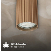 Spot de plafond cylindrique avec structure rainurée.