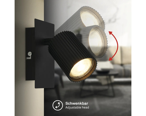 Applique murale noire avec tête de lampe orientable et nervurée pour un éclairage ciblé.