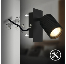 Schéma de montage d'un spot mural noir avec support mural, vis, câble, tête de lampe éclairée et symbole pour le montage.