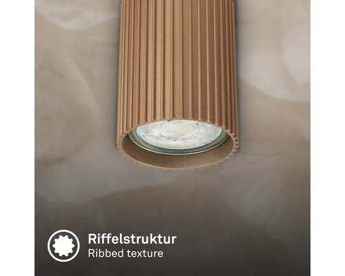 Spot de plafond cylindrique avec structure rainurée.
